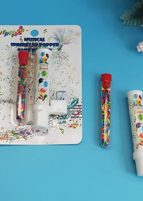 Birthday cake with blue frosting, candles, and confetti on a white background